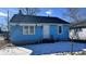 Charming blue house with a white door and awning, nestled on a lot with a small lawn at 901 W Marsh St, Muncie, IN 47303