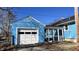 Attached garage with a white door, next to a screened porch at 901 W Marsh St, Muncie, IN 47303