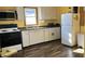 Bright kitchen with yellow walls, white cabinets, and modern appliances at 901 W Marsh St, Muncie, IN 47303