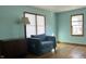 Living room with hardwood floors, large windows, and a covered couch at 901 W Marsh St, Muncie, IN 47303