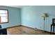 Spacious living room featuring hardwood floors and light teal walls at 901 W Marsh St, Muncie, IN 47303