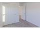 Spacious bedroom featuring grey carpet and double door closet at 902 Stonehaven Dr, Indianapolis, IN 46239