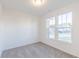 Bright bedroom with grey carpet and two large windows at 902 Stonehaven Dr, Indianapolis, IN 46239