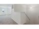 Upstairs hallway with carpet and access to bedrooms at 902 Stonehaven Dr, Indianapolis, IN 46239