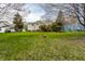 Spacious backyard with lush green grass and a classic brick fire pit at 9229 Thrushwood Ln, Indianapolis, IN 46250