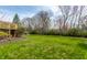 Well-maintained backyard with green grass, mature trees, and a wooden deck at 9229 Thrushwood Ln, Indianapolis, IN 46250