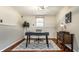 Basement office area showcasing a modern desk, stylish chair, and wood-look floors at 9229 Thrushwood Ln, Indianapolis, IN 46250
