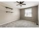 A carpeted bedroom featuring a window, floating shelves and ceiling fan at 9229 Thrushwood Ln, Indianapolis, IN 46250