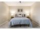 Cozy bedroom features neutral walls and carpet, with decorative lamps and a comfortable bed at 9229 Thrushwood Ln, Indianapolis, IN 46250