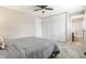 Bedroom with a ceiling fan, large closets, and an en suite bathroom at 9229 Thrushwood Ln, Indianapolis, IN 46250