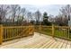 Large wood deck with wooden railings overlooking a lush backyard at 9229 Thrushwood Ln, Indianapolis, IN 46250