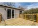 A wooden deck featuring tan siding, a sliding glass door, and a wooden railing at 9229 Thrushwood Ln, Indianapolis, IN 46250