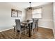 Modern dining room featuring a wood table with seating for four and a stylish overhead light fixture at 9229 Thrushwood Ln, Indianapolis, IN 46250