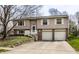 Split-level home featuring neutral siding, a two-car garage, and a well-maintained front lawn at 9229 Thrushwood Ln, Indianapolis, IN 46250