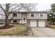 Charming split-level home featuring a two-car garage and a welcoming front entrance with stairs at 9229 Thrushwood Ln, Indianapolis, IN 46250