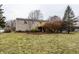 View of the home's exterior with a spacious backyard and a wooden deck, perfect for outdoor enjoyment at 9229 Thrushwood Ln, Indianapolis, IN 46250