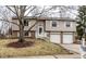 Charming split-level home featuring a two-car garage and a welcoming front entrance with stairs at 9229 Thrushwood Ln, Indianapolis, IN 46250