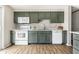 Bright kitchen featuring green cabinets, white appliances, and stylish backsplash for a modern, clean look at 9229 Thrushwood Ln, Indianapolis, IN 46250