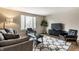 Modern living room featuring a large window, stylish furniture, and a contemporary rug at 9229 Thrushwood Ln, Indianapolis, IN 46250