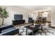 Stylish living room open to dining area, featuring modern furniture and ample natural light at 9229 Thrushwood Ln, Indianapolis, IN 46250