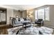 Bright living room with a comfortable sofa, patterned rug, and ample natural light from the large window at 9229 Thrushwood Ln, Indianapolis, IN 46250