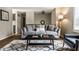 Comfortable living room with a cozy gray sofa, patterned rug, and natural light from the window at 9229 Thrushwood Ln, Indianapolis, IN 46250