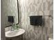 Stylish powder room with geometric wallpaper and a sleek sink at 9426 Orchard Cove Dr, Indianapolis, IN 46239