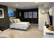 Basement bedroom with dark walls, plush bedding, and media center at 9426 Orchard Cove Dr, Indianapolis, IN 46239