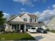 Charming two-story home boasts a three car garage, and a beautifully landscaped front yard, creating curb appeal at 9426 Orchard Cove Dr, Indianapolis, IN 46239