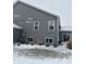 Gray house with snowy yard, and multiple windows at 9426 Orchard Cove Dr, Indianapolis, IN 46239