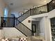 Modern dark wood staircase with metal railings at 9426 Orchard Cove Dr, Indianapolis, IN 46239