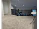 Upper level hallway with carpeted flooring and dark wood railing at 9426 Orchard Cove Dr, Indianapolis, IN 46239