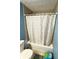 Clean bathroom with shower/tub combo, tile flooring, and a shower curtain at 9519 Meadowlark Dr, Indianapolis, IN 46235