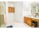 Well-lit bathroom with double vanity, shower, and linen storage at 965 Driftwood Ave, Columbus, IN 47203