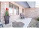 Front porch with brick columns and a small sitting area at 965 Driftwood Ave, Columbus, IN 47203