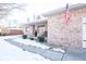 Brick house exterior with a flag and snowy landscaping at 965 Driftwood Ave, Columbus, IN 47203