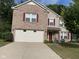 Two-story brick house with a white garage door and landscaped yard at 10391 Butler Dr, Brownsburg, IN 46112