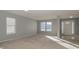Spacious living room with neutral walls, carpeting, and large windows at 10391 Butler Dr, Brownsburg, IN 46112