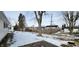 Fenced backyard with mature trees and a partially snow-covered lawn at 11 Eastridge Dr, Greenwood, IN 46143