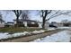 Brick ranch home with attached garage and mature trees in front yard at 11 Eastridge Dr, Greenwood, IN 46143