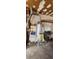 Unfinished garage with water heater and storage at 11 Eastridge Dr, Greenwood, IN 46143
