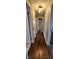 Long hallway with dark hardwood floors and neutral walls at 11 Eastridge Dr, Greenwood, IN 46143