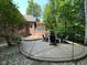Beautiful backyard patio with fire pit and screened-in porch, surrounded by mature trees and professional landscaping at 11253 Loch Raven Blvd, Fishers, IN 46037