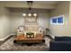 Finished basement seating area with a large coffee table, perfect for relaxing and entertaining at 11253 Loch Raven Blvd, Fishers, IN 46037