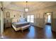 Beautiful main bedroom featuring a tray ceiling, wood floors, and an elegant ensuite entrance at 11253 Loch Raven Blvd, Fishers, IN 46037