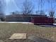 Ranch house with a red deck and spacious backyard at 116 Kenova Dr, Indianapolis, IN 46227