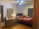 Bright bedroom with a double bed, dresser, and hardwood floors at 116 Kenova Dr, Indianapolis, IN 46227