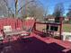 Red wooden deck with patio furniture and backyard view at 116 Kenova Dr, Indianapolis, IN 46227