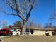 House exterior showcasing a large tree and front yard at 116 Kenova Dr, Indianapolis, IN 46227