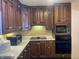 Kitchen with dark wood cabinets and appliances at 116 Kenova Dr, Indianapolis, IN 46227
